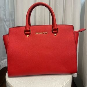 Red leather tote bag with gold hardware